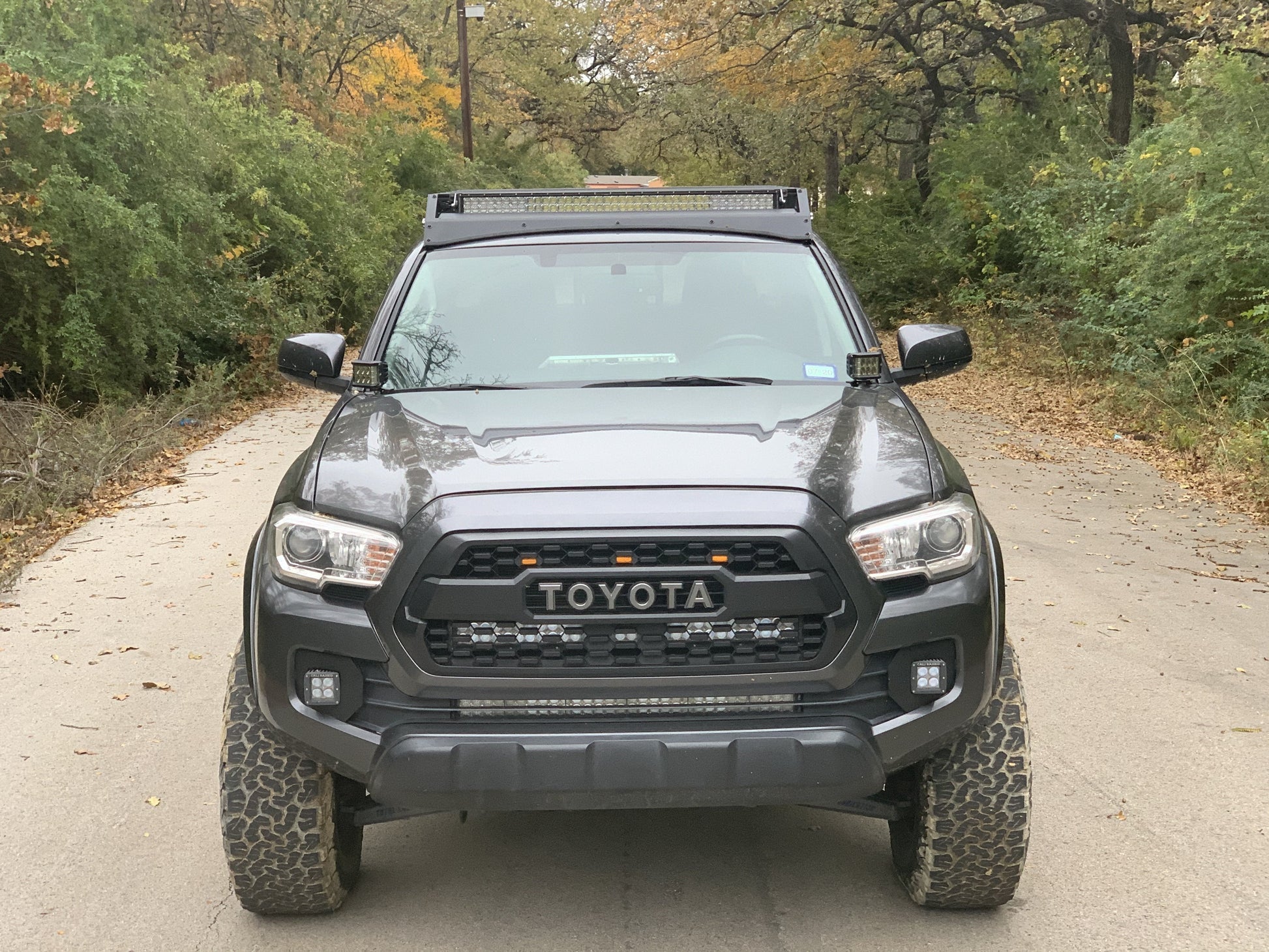 Front view of gray Toyota Tacoma with Premium roof rack with covered light bar - Cali Raised LED